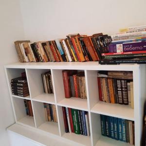 a white book shelf filled with lots of books at "Whispering pines" vacation home, close to Sofia in Gola Glava