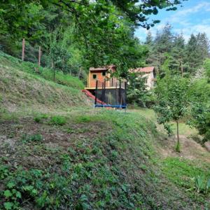 a house on top of a hill with a playground at "Whispering pines" vacation home, close to Sofia in Gola Glava
