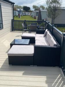 a patio with two beds on a deck at Boulevard in Selsey