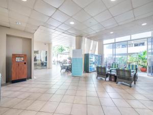 a lobby with chairs and tables in a building at Penthouse in Waikiki with ocean & mountain views in Honolulu