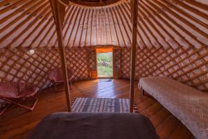 a room with a yurt with a bed and a window at Yourte Mongole Insolite - Gîte Saint Roch in Tuchan