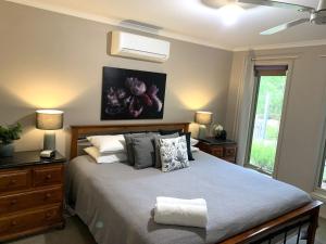 a bedroom with a large bed and a window at Bella Nicola in Bright