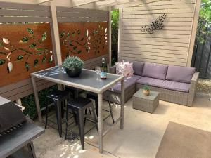 a patio with a table and a purple couch at Bella Nicola in Bright