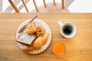 a plate of pastries on a table with a cup of coffee at Hotel Wing International Shonan Fujisawa in Fujisawa