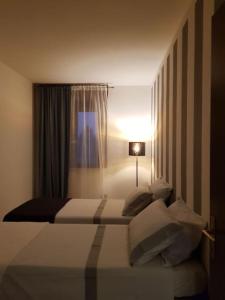 a hotel room with a bed and a window at Cozy Home in Sommacampagna