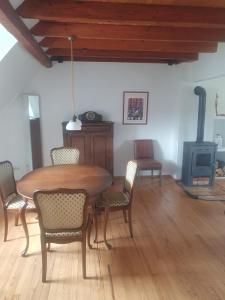 a dining room with a table and chairs and a stove at Ferienwohnung Katrin in Mettlach