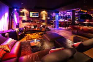 a living room with couches and a bar at pentahotel Brussels City Centre in Brussels