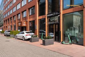 a white car parked in front of a building at Luxury Suites - Rotermann by Rikas Hotels in Tallinn