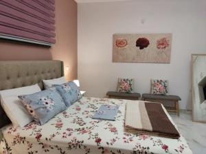 a bedroom with a large bed with flowers on it at Ebony and Ivory Suites in Drosia