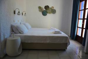 Postel nebo postele na pokoji v ubytování Poseidon Blue Gastronomy Hotel