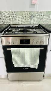 a stove top oven with a towel on it at Robyns Nest 3 Self Catering Flat in Kloof