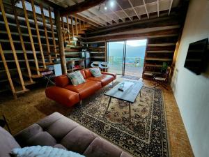 a living room with a couch and a table at Villa Keys in Wilderness