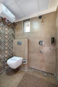 a bathroom with a toilet and a shower at Palm Stay - Studios & Rooms in Jaipur