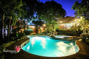 a swimming pool in front of a house at night at Bubinzana Magical Lodge in Tarapoto