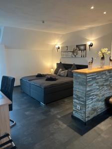 a bedroom with a bed and a table in it at Hotel zur Wasserburg in Kerpen