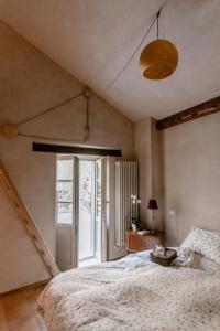 a bedroom with a large bed and a window at Roero House in Magliano Alfieri