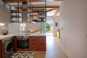 a kitchen with a sink and a washer and dryer at Angestrale Traditional Residence in Lefkada Town