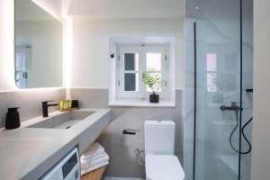 a bathroom with a toilet and a sink and a shower at Angestrale Traditional Residence in Lefkada Town +36 photos
