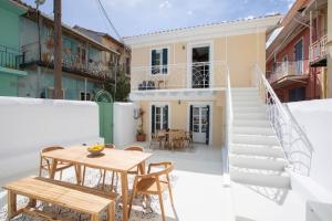 a patio with a table and chairs and a staircase at Angestrale Traditional Residence in Lefkada Town