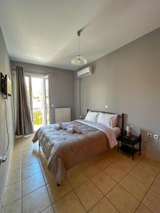 a bedroom with a large bed and a window at CENTRAL APARTMENTs in Ermoupoli