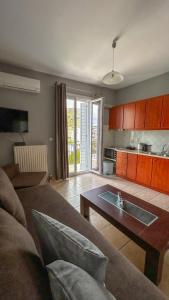 a living room with a couch and a table at CENTRAL APARTMENTs in Ermoupoli