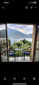 a view of a table and chairs on a balcony at Lake Como View Apartement Allegro in Acquaseria