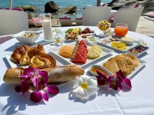 a table with a tray of breakfast foods on it at Beluga Boutique Hotel in Lamai