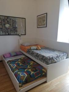 two twin beds in a room with at La casa di Rina in Ponzone
