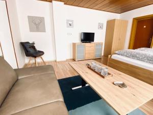 a living room with a bed and a coffee table at FEWO Vanessa in Willingen