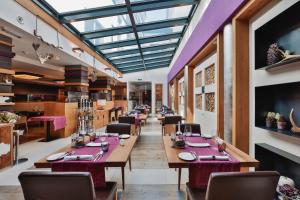 a dining room with wooden tables and chairs at Hotel Fliana Ischgl in Ischgl