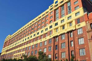 a large brick building with a yellow at Darling Harbour Studio w Pool Sauna Gym Jacuzzi in Sydney