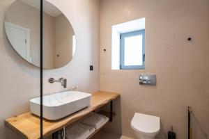 a bathroom with a sink and a mirror at Eden Kythira in Dhiakofti