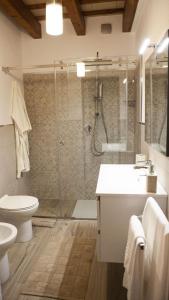 a bathroom with a shower and a toilet and a sink at casa vacanza zu ciano in Marausa
