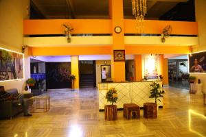 a lobby of a building with orange walls and wooden floors at Country Inn By Turtle Hotel and Resort- Mumbai International Airport in Mumbai