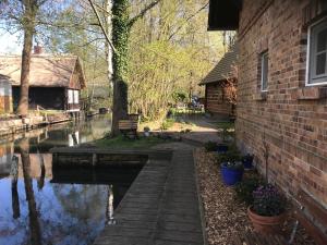 a house next to a river next to a building at Spreewaldinsel Leipe in Leipe