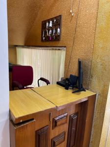 a desk with a computer on top of it at Castle 360 Residency in Pondicherry