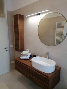 casa a due passi dal centro في بادوفا: حمام مع حوض أبيض ومرآة