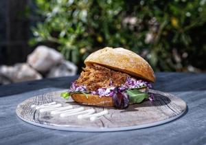 a sandwich on a plate on a table at Hotel Ankaa - Adults Only in Porto Cristo