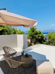 a patio with a chair and an umbrella at Ether Apartment By The Sea Ι in Theologos
