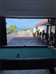 a pool table in a room with a view of the ocean at 2 bedroom Apartment -Villa Ibiza in Trou d'Eau Douce