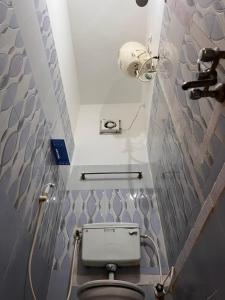 a bathroom with a toilet in a small room at Castle 360 Residency in Pondicherry