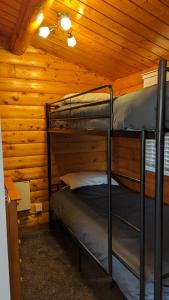 a bedroom with two bunk beds in a cabin at Snowdonia Log cabin in Trawsfynydd