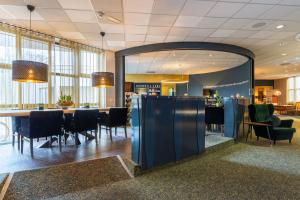 a dining room with a table and chairs at Amrâth Berghotel Amersfoort, BW Signature Collection in Amersfoort