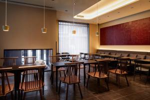 a dining room with wooden tables and chairs at Agora Kyoto Shijo in Kyoto