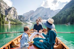 a family in a boat on a lake at Hotel Fameli in Valdaora