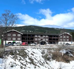 a large building with snow in front of it at Trysil-Knut Hotel in Trysil