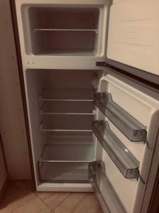 an empty refrigerator with its door open in a kitchen at Villa Ceni 3 in Elbasan