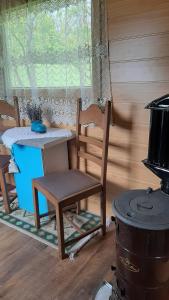 a room with a table and a chair and a stove at Poiana Stelelor 