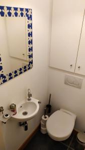 bagno con servizi igienici, lavandino e specchio di Penthousebeach a Koksijde