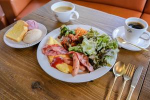 a table with a plate of food and a cup of coffee at Agora Place Tokyo Asakusa in Tokyo